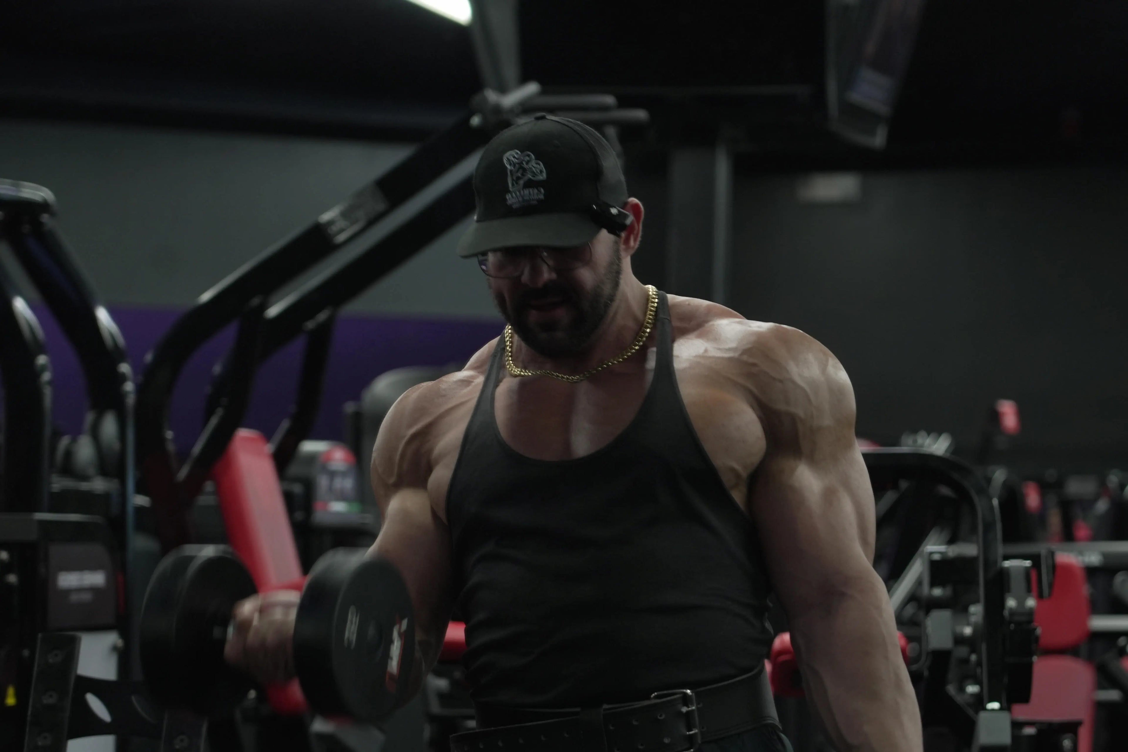 Muscular man lifting weights in a gym setting