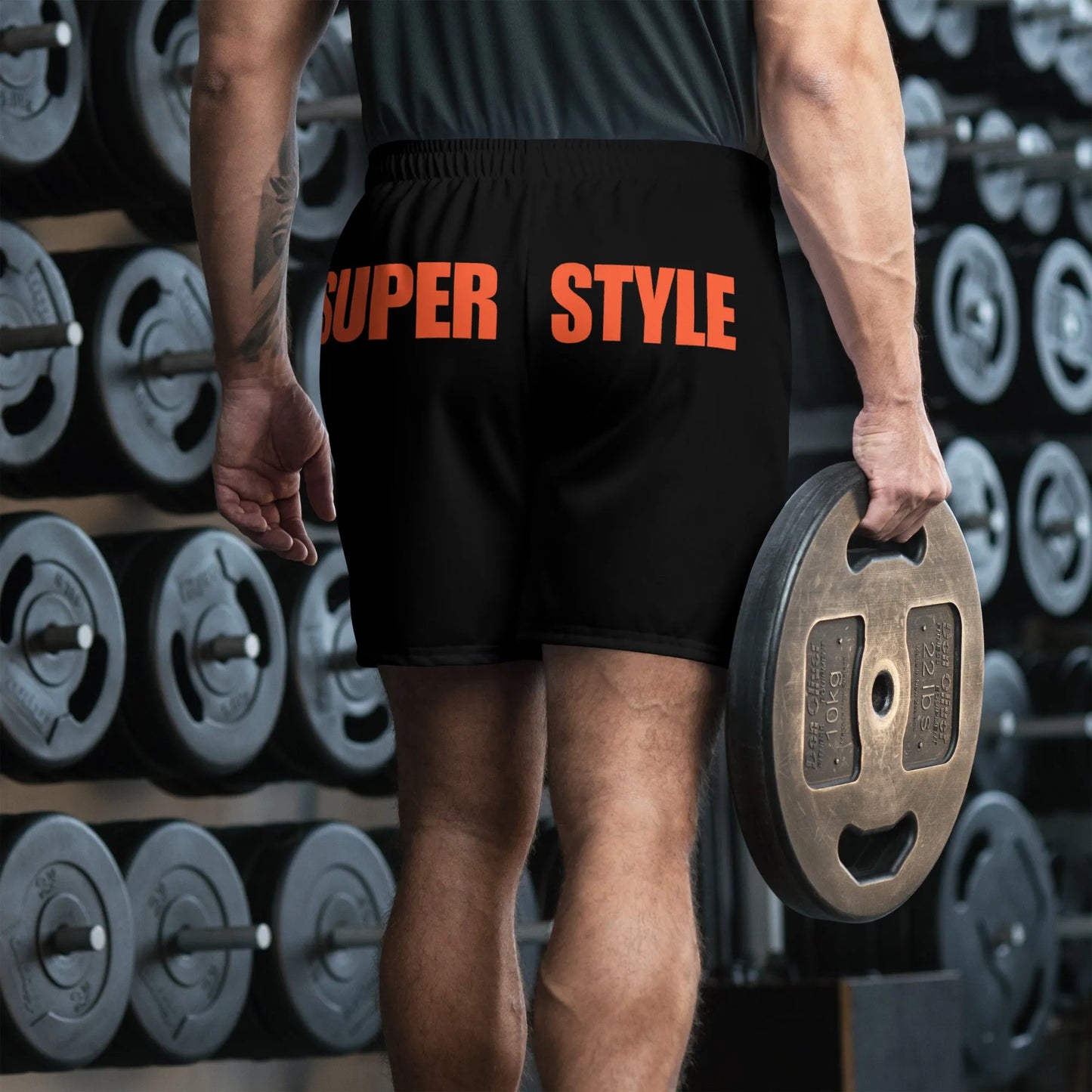 Male athlete wearing Super Style black performance shorts with rear orange branding.