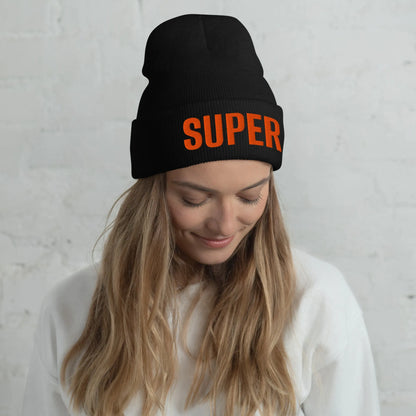 Model wearing black SUPER cuffed beanie with orange embroidery in lifestyle setting
