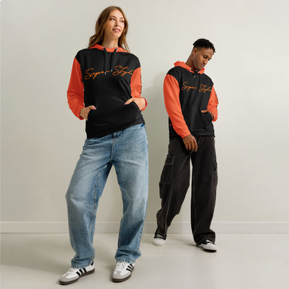 Two people wearing matching hoodies with orange sleeves and black bodies against a plain background
