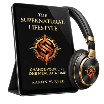 Angled view of a tablet standing on a case next to luxury black and gold-trimmed headphones featuring The Supernatural Lifestyle branding by Aaron W Reed.