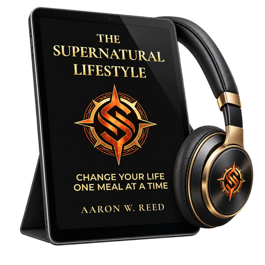Angled view of a tablet standing on a case next to luxury black and gold-trimmed headphones featuring The Supernatural Lifestyle branding by Aaron W Reed.