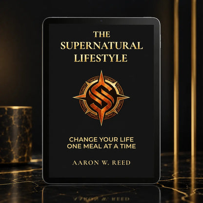 Front-facing mockup of The Supernatural Lifestyle e-book on a tablet device placed on a luxurious dark marble table.