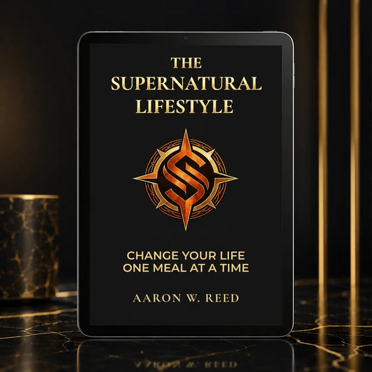 Front-facing mockup of The Supernatural Lifestyle e-book on a tablet device placed on a luxurious dark marble table.
